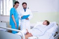 Doctor and nurse discussing over patient s leg Royalty Free Stock Photo