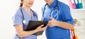 Doctor and nurse discussing something in the clinic. Two doctors in medical office close up image Royalty Free Stock Photo