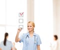 Doctor or nurse drawing checkmark into checkbox Royalty Free Stock Photo