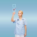 Doctor or nurse drawing checkmark into checkbox Royalty Free Stock Photo