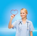 Doctor or nurse drawing red heart Royalty Free Stock Photo