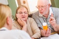 Doctor or Nurse Explaining Prescription Medicine to Senior Adult Couple Royalty Free Stock Photo