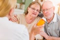 Senior Couple Consulting with Doctor or Nurse Explaining Prescription Medicine Royalty Free Stock Photo