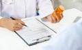 Doctor or nurse hand write a prescription and holding medicine pill bottle at the pharmacy office, healthcare, and medical check- Royalty Free Stock Photo