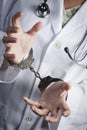 Doctor or Nurse In Handcuffs Wearing Lab Coat and Stethoscope Royalty Free Stock Photo