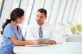 Doctor And Nurse Having Informal Meeting In Hospital Canteen