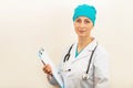 Doctor or nurse holding hands clipboard on beige background, measles injection syringe for baby, man, woman vaccination