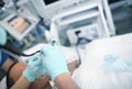 Doctor with a nurse in intensive care perform the procedure on an unconscious patient