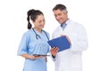 Doctor and nurse looking at clipboard Royalty Free Stock Photo