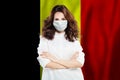 Doctor or nurse in medical safety face mask on Belgian flag background. Flu epidemic and protection in Belgium concept Royalty Free Stock Photo