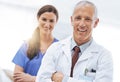 Doctor, nurse and partner in portrait with arms crossed, medical support and wellness at hospital. Medic, mature man and Royalty Free Stock Photo