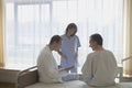 Doctor And Nurse With Patient In Hospital Room