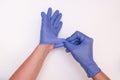 Doctor or nurse putting on blue nitrile surgical gloves, professional medical safety and hygiene for surgery and medical exam, Royalty Free Stock Photo