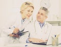 Doctor and nurse reading information Royalty Free Stock Photo