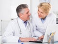 Doctor and nurse reading information Royalty Free Stock Photo