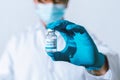Doctor, nurse, scientist hand in blue gloves holding flu, measles, coronavirus, covid-19 vaccine disease preparing vaccination Royalty Free Stock Photo