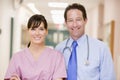 Doctor And Nurse Standing In A Hospital Corridor Royalty Free Stock Photo