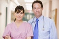 Doctor And Nurse Standing In A Hospital Corridor Royalty Free Stock Photo