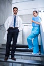 Doctor and nurse standing on staircase Royalty Free Stock Photo