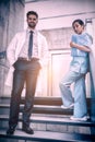 Doctor and nurse standing on staircase Royalty Free Stock Photo
