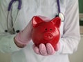 Doctor nurse with stethoscope holding piggy bank Royalty Free Stock Photo