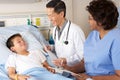 Doctor And Nurse Visiting Child Patient On Ward Royalty Free Stock Photo