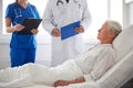 Doctor and nurse visiting senior woman at hospital Royalty Free Stock Photo