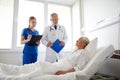 Doctor and nurse visiting senior woman at hospital Royalty Free Stock Photo