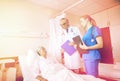 Doctor and nurse visiting senior woman at hospital Royalty Free Stock Photo