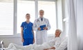 Doctor and nurse visiting senior woman at hospital Royalty Free Stock Photo