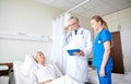 Doctor and nurse visiting senior woman at hospital Royalty Free Stock Photo