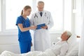 Doctor and nurse visiting senior woman at hospital Royalty Free Stock Photo