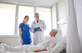 Doctor and nurse visiting senior woman at hospital Royalty Free Stock Photo