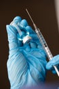 Doctor or Nurse Wearing Surgical Gloves Holding Vaccine Vial and Medical Syringe Royalty Free Stock Photo