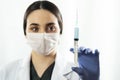 Doctor or nurse woman holds injection syringe and vaccine Royalty Free Stock Photo