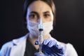 Doctor or nurse woman holds injection syringe and vaccine Royalty Free Stock Photo