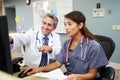 Doctor With Nurse Working At Nurses Station Royalty Free Stock Photo