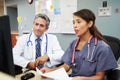 Doctor With Nurse Working At Nurses Station Royalty Free Stock Photo