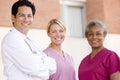 Doctor And Nurses Standing Outside A Hospital Royalty Free Stock Photo