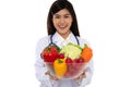 Doctor or nutritionist holding fresh fruit Orange, red and green apples and smile in clinic. Healthy diet Concept of nutrition Royalty Free Stock Photo