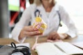 Doctor nutritionist holding ripe yellow pear with measuring tape Royalty Free Stock Photo