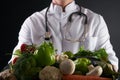 Doctor nutritionist holding tray with heart healthy foods vegetables and fruits