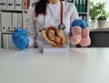 Doctor obstetrician gynecologist showing fetus in uterus of anatomical model of human organ