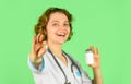 Doctor is offering to drug tablet. introducing the properties of the painkiller. Female doctor gives jar of pills to Royalty Free Stock Photo