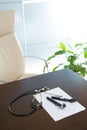 Doctor office table desk with stethoscope and otoscope Royalty Free Stock Photo