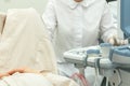 Doctor operating Ultrasound scanner for patient diagnostic