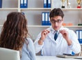 The doctor optician prescribing glasses to a patient