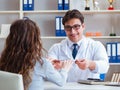 Doctor optician prescribing glasses to a patient