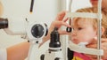 Doctor optometrist checks eyesight at little girl - child`s ophthalmology Royalty Free Stock Photo