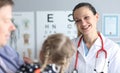 Doctor an optometrist conducts checks vision child